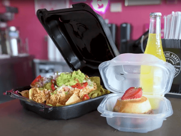 Food service containers filled with Mexican cuisine